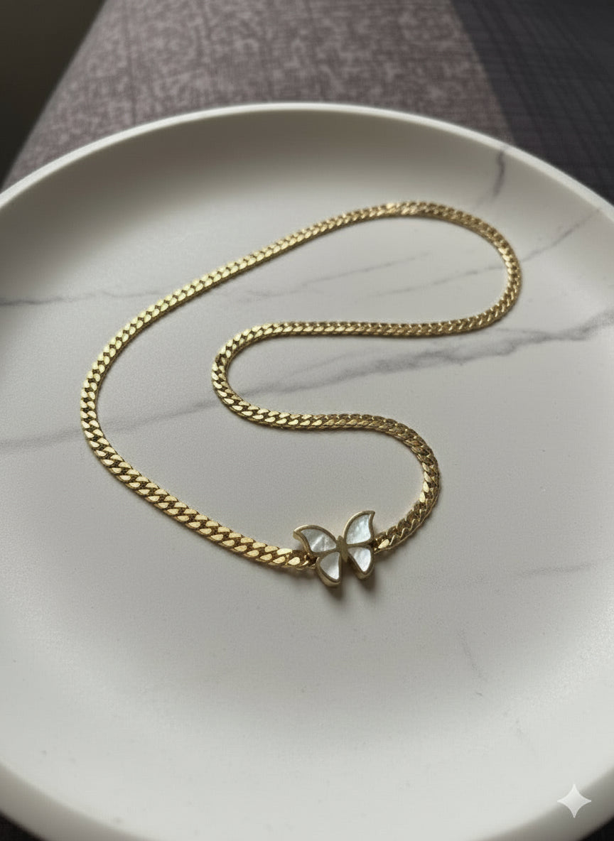 The central feature is a butterfly charm