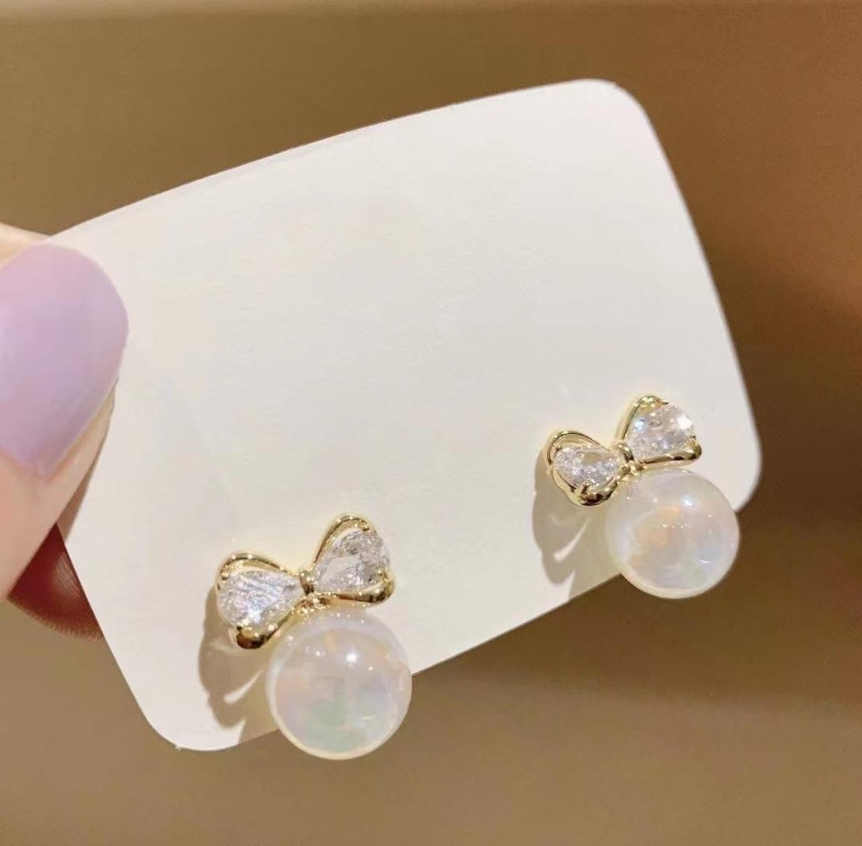 Iridescent Pearl Bow Stud Earrings